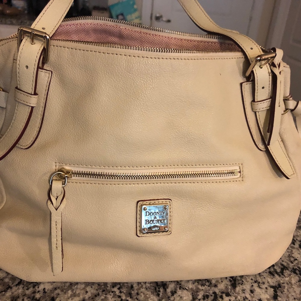 Cream color Dooney leather Handbag in very good condition, size is 10x15.